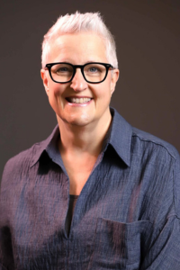 Female, grey hair, blue sweater